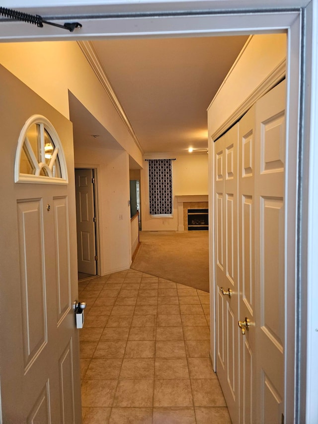 hall featuring light carpet and light tile patterned floors