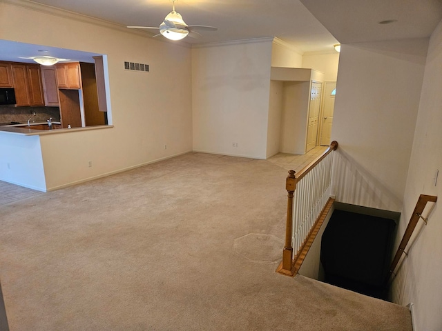 unfurnished living room with visible vents, crown molding, and light carpet