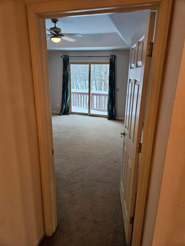 hallway with light carpet and baseboards