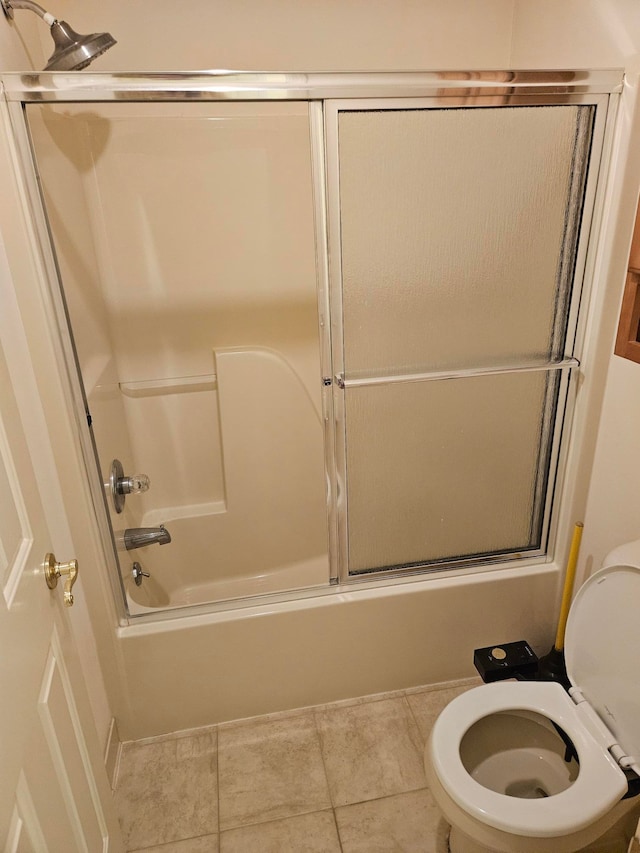 full bath featuring tile patterned flooring, enclosed tub / shower combo, and toilet