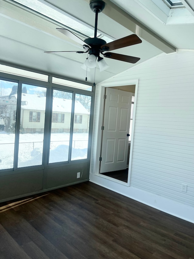 unfurnished sunroom featuring vaulted ceiling with beams and ceiling fan