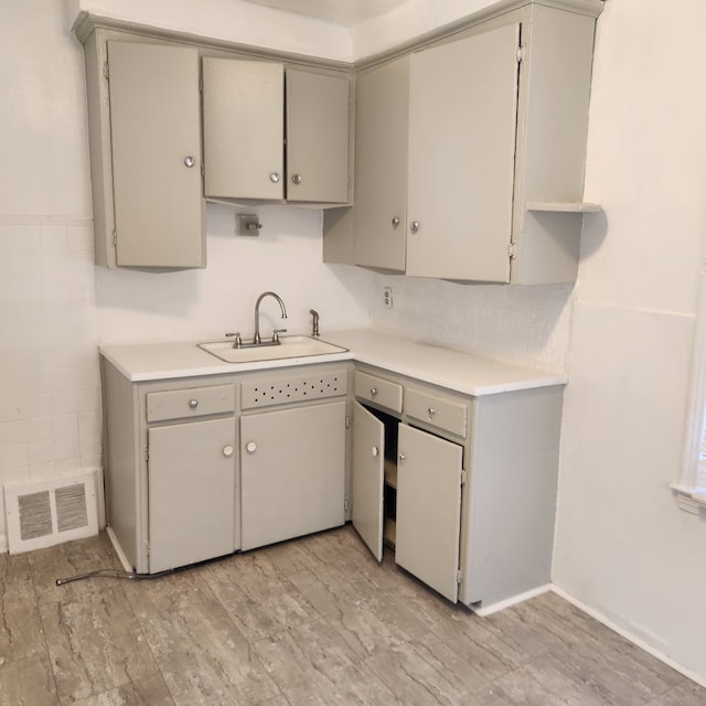 kitchen featuring sink and gray cabinetry