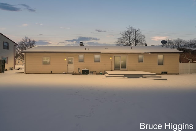 back house at dusk with central AC unit