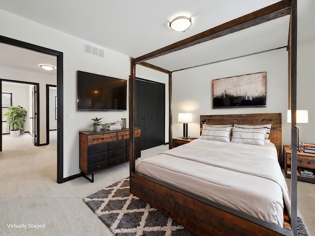 bedroom with visible vents, beam ceiling, and light colored carpet