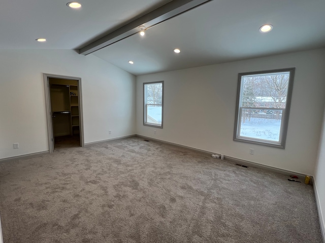 unfurnished room with vaulted ceiling with beams, recessed lighting, visible vents, light carpet, and baseboards