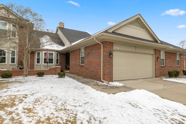 view of snow covered exterior with a garage