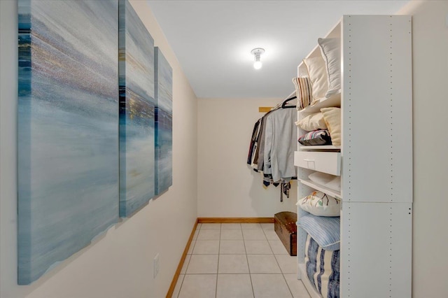 walk in closet with light tile patterned floors