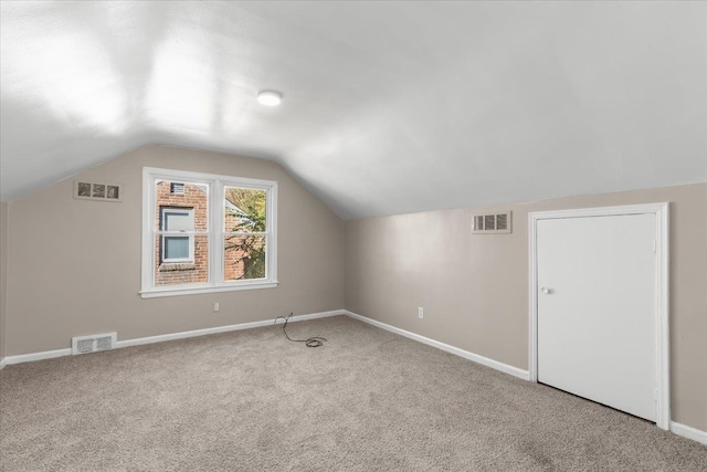 bonus room with carpet and vaulted ceiling