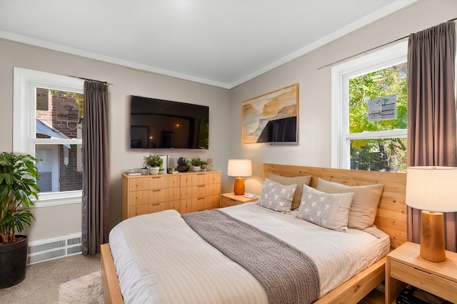 bedroom with multiple windows, carpet floors, and crown molding