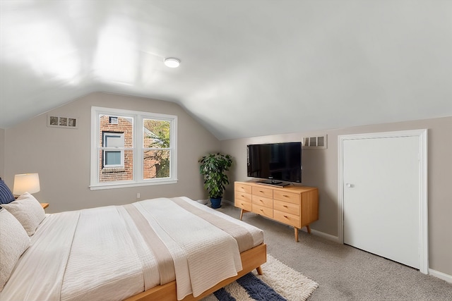 carpeted bedroom featuring vaulted ceiling