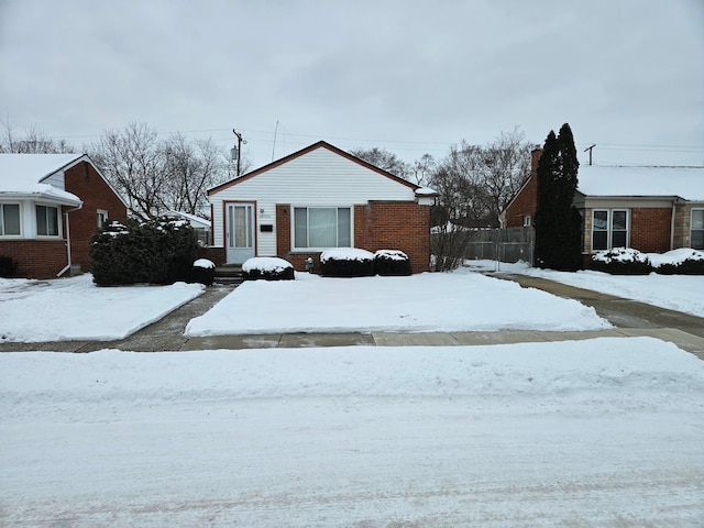 bungalow-style house with brick siding