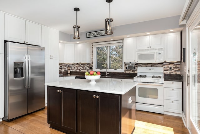 kitchen featuring white cabinetry, white appliances, light wood-type flooring, and a sink