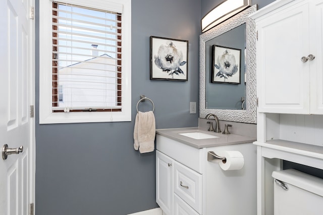 bathroom with toilet and vanity