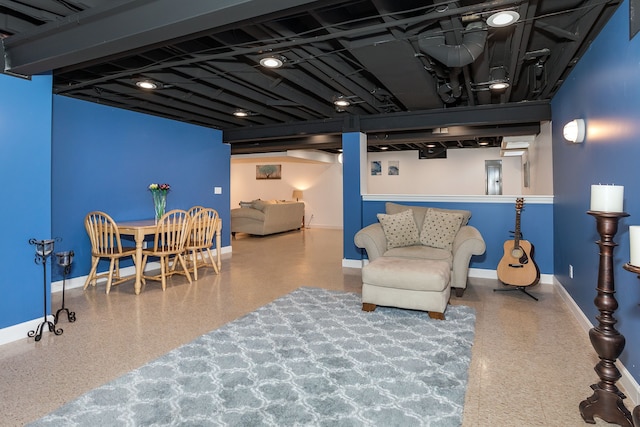 living area with speckled floor and baseboards