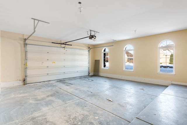 garage featuring baseboards and a garage door opener