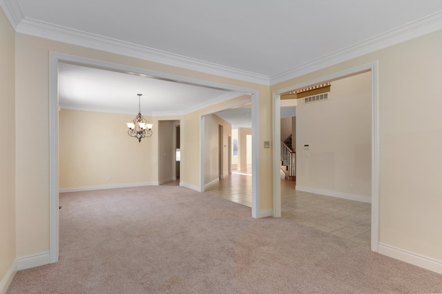 unfurnished room featuring crown molding, visible vents, an inviting chandelier, light carpet, and baseboards