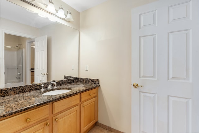 bathroom featuring a shower and vanity