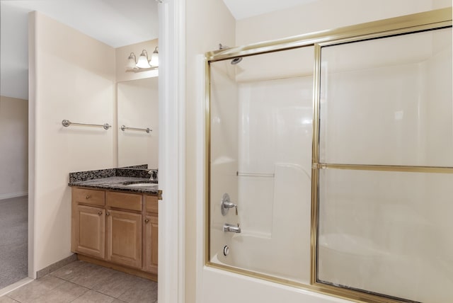 bathroom with baseboards, bath / shower combo with glass door, vanity, and tile patterned floors