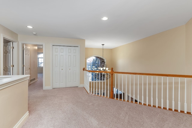 hall with carpet, visible vents, a chandelier, and recessed lighting