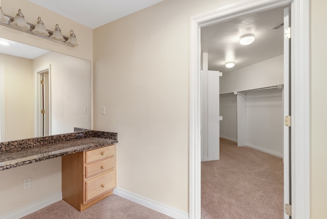 bathroom with vanity and baseboards