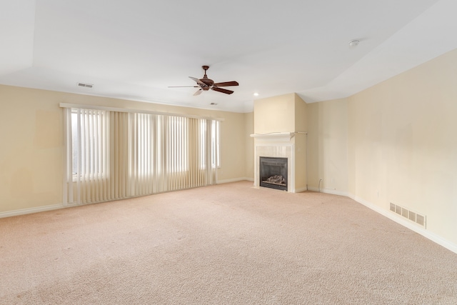 unfurnished living room with a fireplace, visible vents, and a healthy amount of sunlight