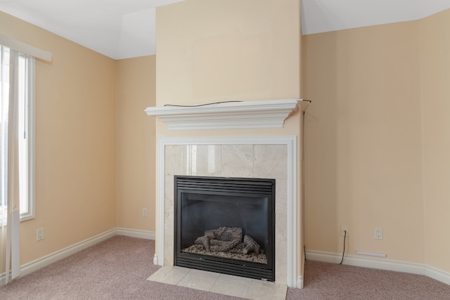 details featuring carpet, baseboards, and a tiled fireplace