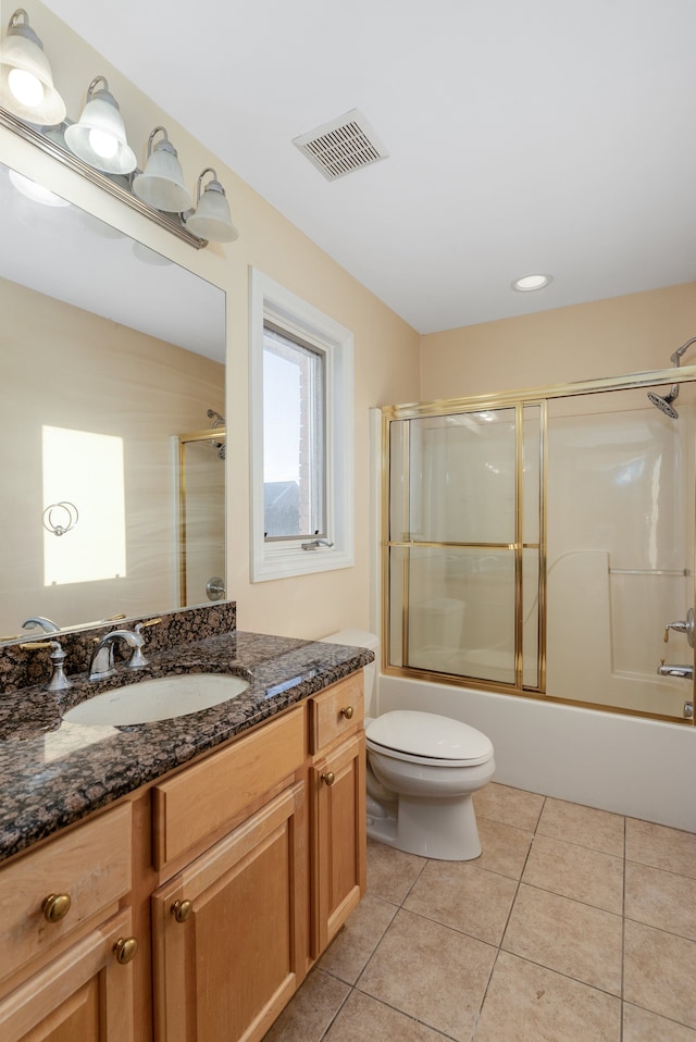 bathroom with shower / bath combination with glass door, visible vents, toilet, vanity, and tile patterned floors