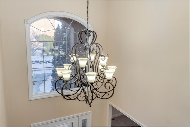 room details with a notable chandelier and baseboards