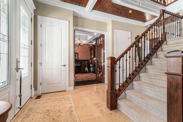 entrance foyer featuring stairs, ornamental molding, coffered ceiling, and beam ceiling