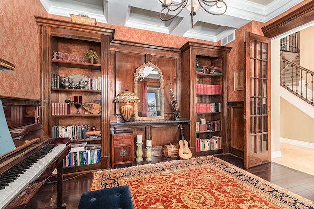 home office featuring visible vents, coffered ceiling, ornamental molding, dark wood-style flooring, and a chandelier