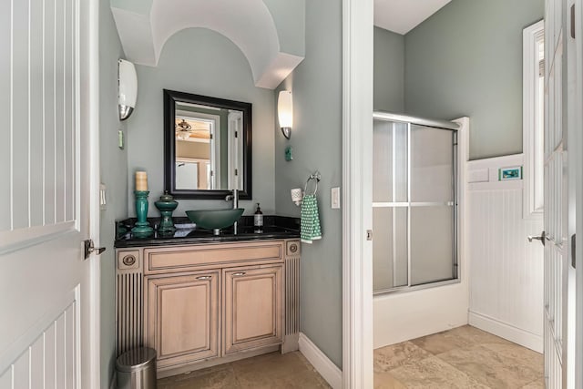 full bathroom featuring shower / bath combination with glass door, baseboards, and vanity