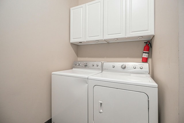 laundry room featuring washer and clothes dryer and cabinet space