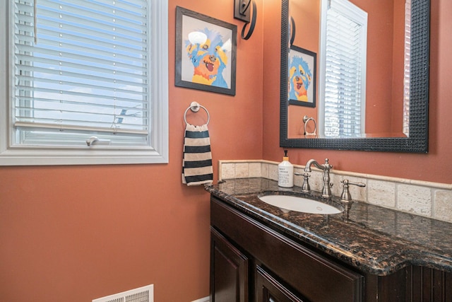 bathroom with vanity and visible vents