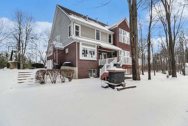 view of front of property with stairs and brick siding