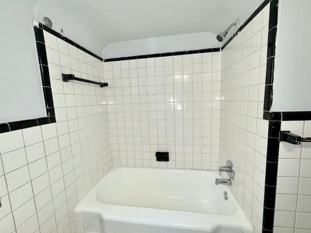 bathroom featuring tub / shower combination and tile walls