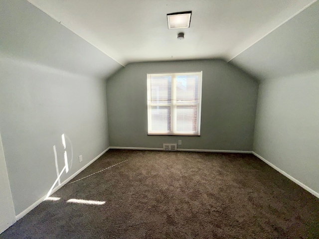 bonus room featuring lofted ceiling, carpet, visible vents, and baseboards