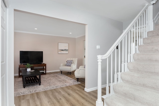 interior space featuring crown molding, baseboards, wood finished floors, and recessed lighting