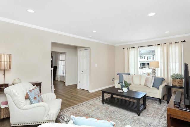 living area featuring ornamental molding, recessed lighting, wood finished floors, and baseboards