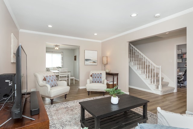 living area featuring baseboards, stairway, wood finished floors, and crown molding