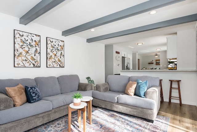 living room featuring recessed lighting, baseboards, beam ceiling, and wood finished floors