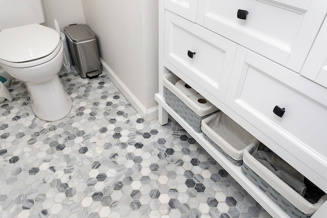 bathroom with baseboards and toilet