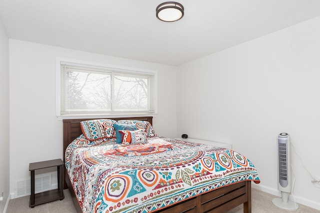 bedroom with carpet floors, visible vents, and baseboards