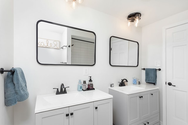 full bath with two vanities and a sink