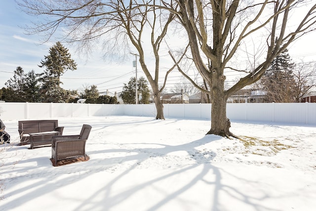 yard covered in snow featuring a fenced backyard