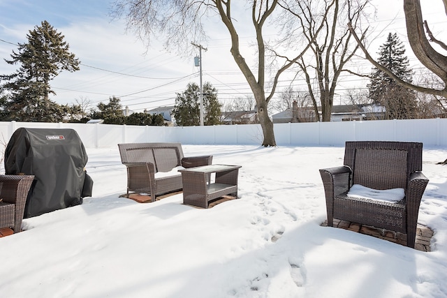 yard covered in snow with a fenced backyard and an outdoor living space