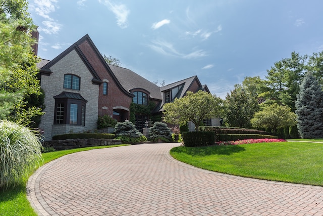 french country style house with a front lawn