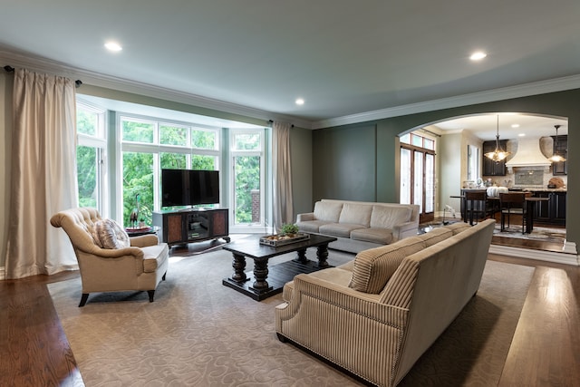 living room with ornamental molding and wood-type flooring