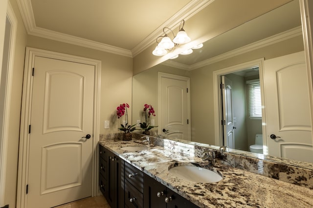 bathroom with vanity, toilet, and ornamental molding