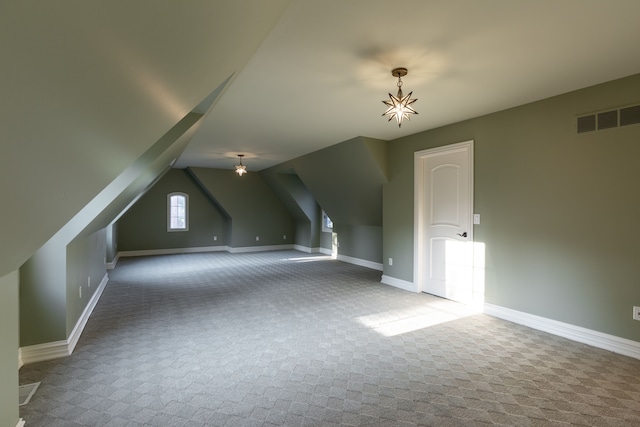 additional living space featuring lofted ceiling and carpet flooring