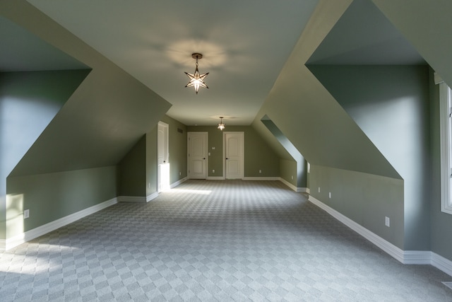 bonus room featuring lofted ceiling and light colored carpet